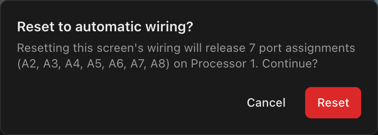 The Reset to automatic wiring? dialog naming the seven port assignments a reset would release on Processor 1, with Cancel and Reset